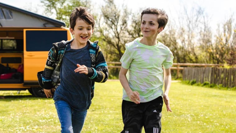 Boys Running In Front Of Campervan 