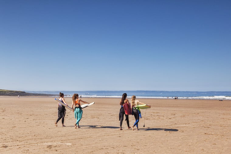 A group of surfers on Croyde Bay