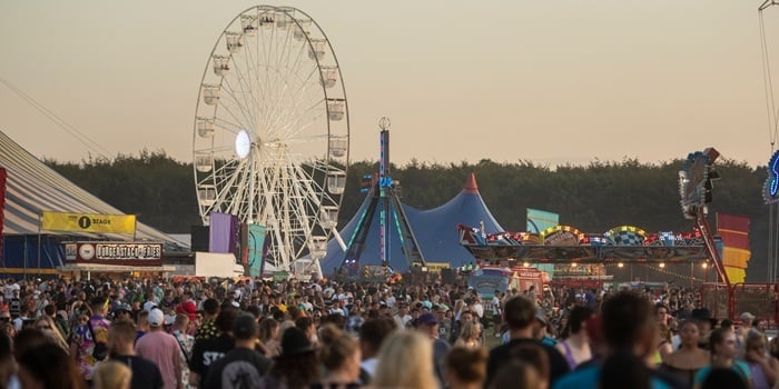 Festival scene with Ferris wheel in the background
