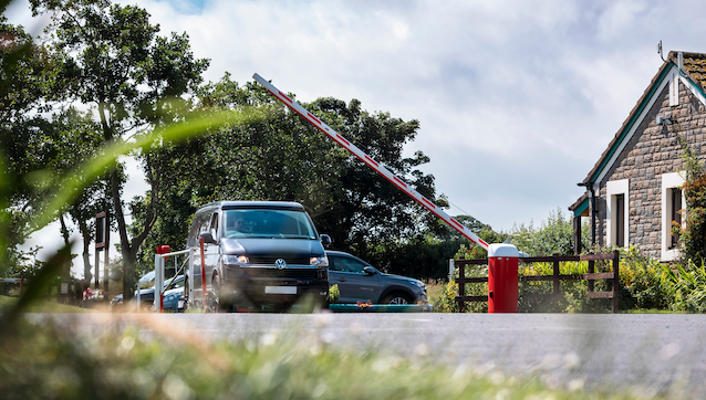 A CamperKing campervan drives under the barrier when arriving at a campsite